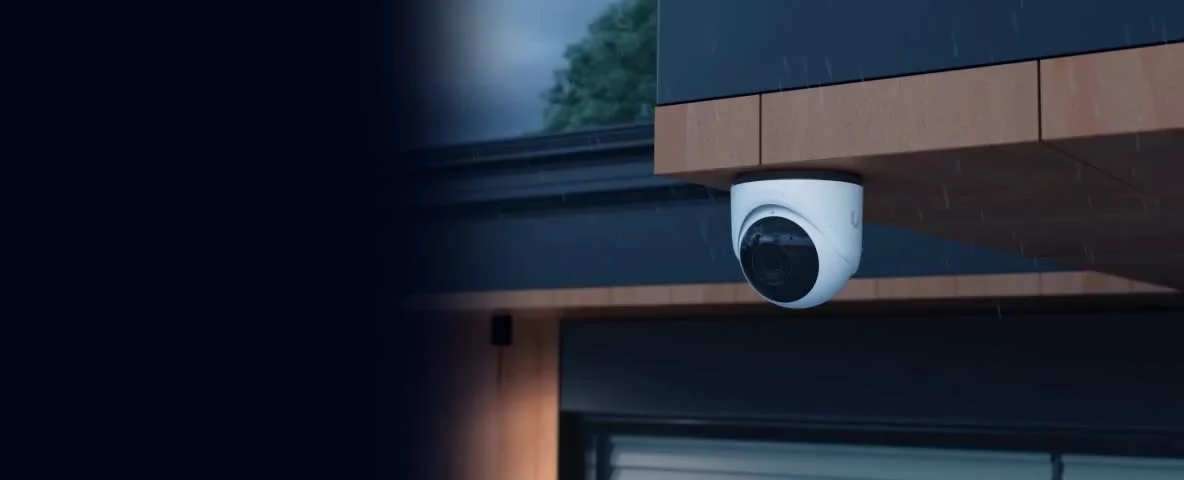 A security camera installed under an exterior roof overhang