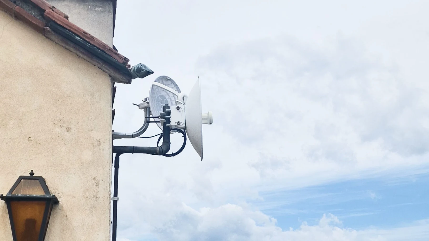 Wireless connectivity equipment mounted outside a hospitality building