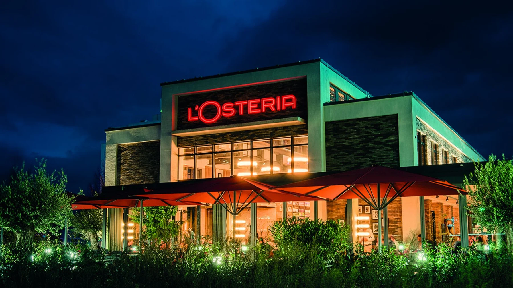 A restaurant exterior photographed after dark